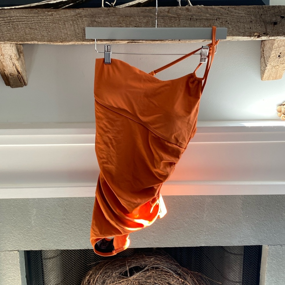 One shoulder style one piece bathing suit.  Pumpkin color.